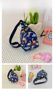 Detail view of kids navy blue sling bag with cartoon dinosaur and unicorn patterns