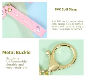 Detailed view of the pink PVC strap and gold metal clasp of the keychain