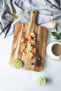 Premium acacia wood cutting board being used as a breakfast serving tray with coffee