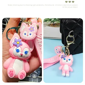Close-up detail of the pink cartoon character keychain featuring a silicone wrist strap