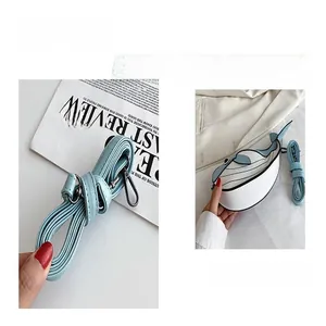 Close-up of cute whale-shaped crossbody bag with blue and white color blocking