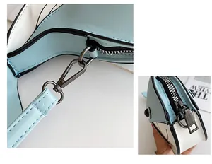 Close-up detail of hardware and zipper on a cute blue whale cartoon crossbody bag.