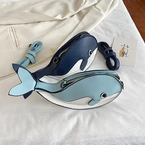 Detail view of cute whale-shaped cartoon crossbody bags in navy and light blue colors