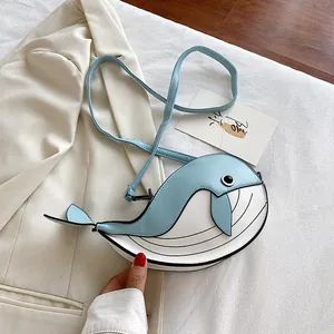 Detailed view of the cute cartoon whale-shaped crossbody bag in blue and white