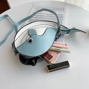 Close-up of kawaii blue whale crossbody bag showing inner capacity for cosmetics.