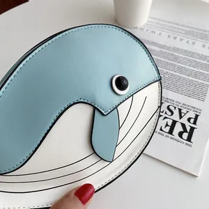 Detail of cute whale-shaped crossbody bag with soft blue and white PU leather