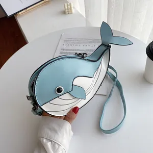 Detailed view of a cute cartoon whale crossbody bag in light blue and white colors