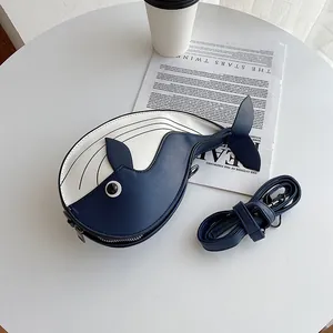 Cute whale-shaped crossbody bag with blue and white color block design and strap