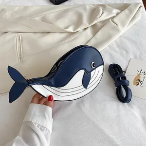 Detailed view of a cute cartoon whale-shaped crossbody bag in blue and white faux leather