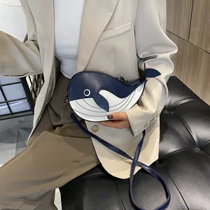Detail shot of a Japanese style cartoon whale crossbody bag with blue and white color-block