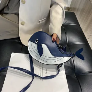 Detail of cute cartoon whale-shaped crossbody bag featuring stylish blue and white design