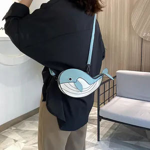 Adorable cartoon whale-shaped crossbody bag featuring a blue and white color-block design