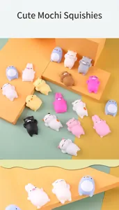 Colorful collection of cute squishy animal toys displayed on pastel geometric blocks.