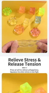 Close-up of transparent cat paw and ice cube stress relief squishy toys being stretched.