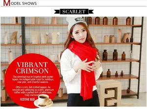 Close-up of a model wearing a bright red soft faux cashmere scarf