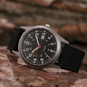 Men's military quartz watch with black canvas strap and date display on rock background