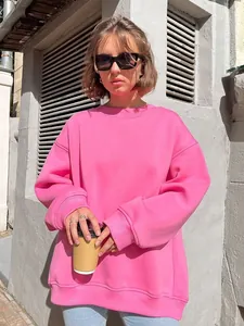 Detailed macro view of vibrant pink oversized crewneck sweatshirt in street style setting