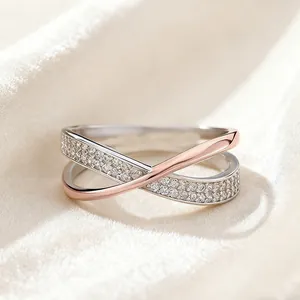 Elegant minimalist X-shaped crossover ring featuring rose gold and silver pave stones