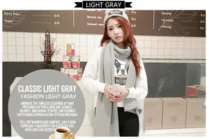 Model wearing a soft light gray imitation cashmere scarf in a cafe setting
