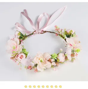 Detailed view of a handmade forest style flower crown with pink faux blossoms and ribbon