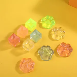 Colorful cute transparent cat paw and ice cube squishy stress relief toys set on yellow
