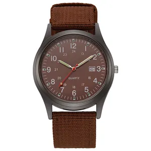 Detail of military style quartz watch with brown canvas strap and date display
