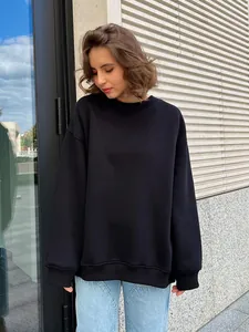 Street style black oversize fleece-lined crewneck sweatshirt shown on a female model