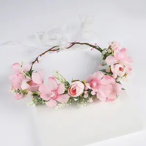 Handmade bridal floral crown with pink faux flowers and white ribbon for weddings