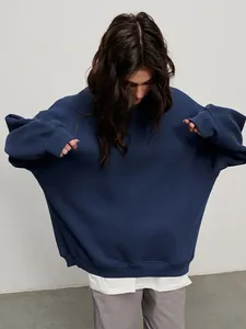 Detail of an oversized navy blue crewneck sweatshirt featuring a relaxed streetwear fit
