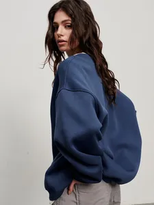 Detailed view of women's oversized blue crew neck sweatshirt in soft fleece fabric