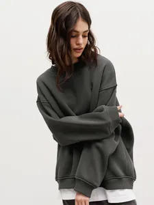 Close-up detail of oversized dark grey crewneck sweatshirt in soft fleece material