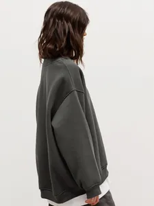 Side view of oversized charcoal grey crewneck sweatshirt in a soft fleece fabric.
