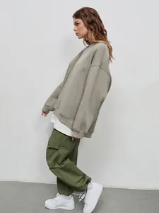 Side view showing the relaxed fit and sage green color of the polar fleece sweatshirt