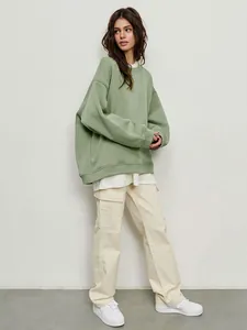 Detailed view of a stylish oversized light green crewneck sweatshirt for women.