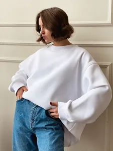 Close-up of a white oversized crewneck sweatshirt showing loose fit and soft fabric