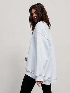 Side view of an oversized light blue crewneck sweatshirt in a soft fleece fabric.