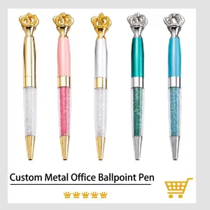 Five crown-topped metal ballpoint pens in assorted colors with glitter accents.