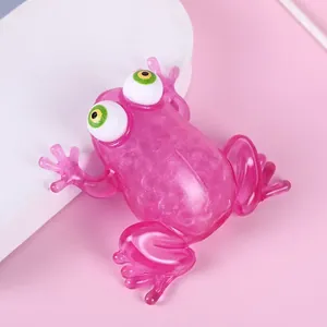 Close-up of pink translucent frog squeeze toy with bulging eyes and water beads