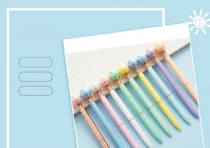 Row of macaron-colored pearl-top metal ballpoint pens in pastel finishes.