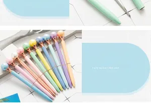 Detailed view of colorful pearl top metal ballpoint pens in soft pastel macaron shades