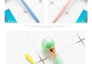 Close-up of elegant metal ballpoint pens with colorful pearl tops in pastel shades