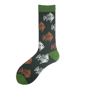 Close-up view of dark grey crew socks with green accents and fish skeleton patterns.