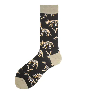 Detailed view of black crew socks with fun dinosaur skeleton pattern and tan accents