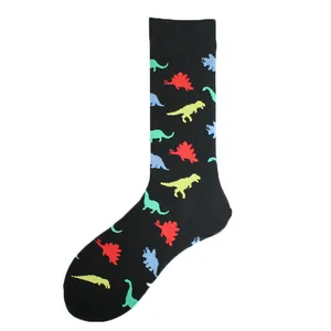 Macro view of black crew socks with vibrant, colorful dinosaur silhouette patterns.
