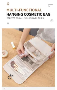 Detail of cream travel toiletry bag showing mesh pockets and brush holders on wood
