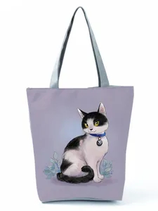 Detail view of a cute cartoon cat print tote bag for women in light purple style.