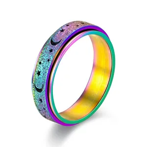 Rainbow iridescent rotatable stress relief spinner ring featuring star and moon cutouts