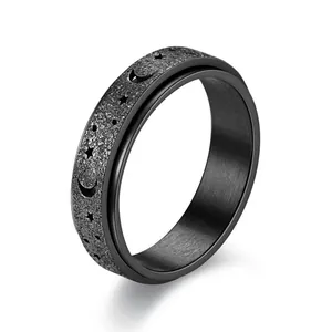 Black stainless steel spinner ring with star and moon cutout designs for stress relief.
