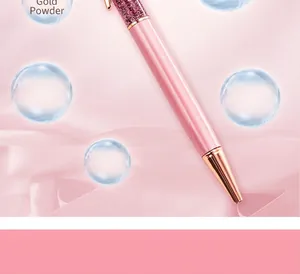 Close-up of pink glitter metal ballpoint pen with elegant rose gold accents and pink background.