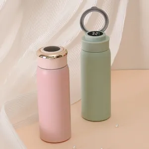 Close-up of pastel insulated bottle with digital temperature display and ring handle lid.